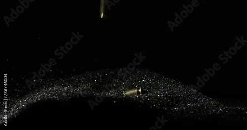 6mm ARC bullets falling into gunpowder dust pile in slow motion, detail closeup photo