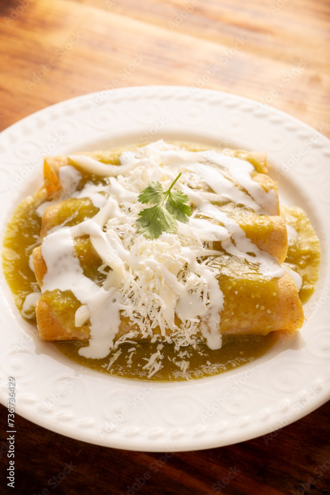 Green enchiladas. Typical Mexican dish made with a folded or rolled