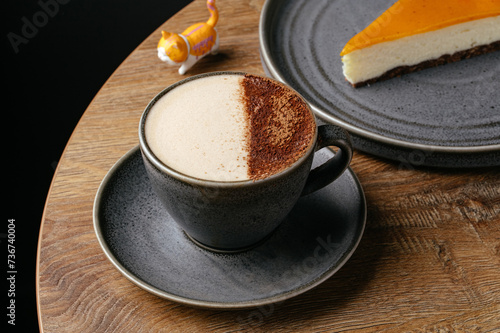 cappuccino in a mug and dessert on a plate. coffee shop menu
