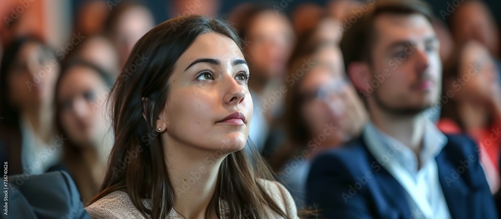 A woman is enjoying the fashion design event in a fun crowd, sharing the moment with the audience as a fan, while her eyelashes flutter with excitement A woman is enjoying the fashion design event in a fun crowd, sharing the moment with the audience as a fan, while her eyelashes flutter with excitement