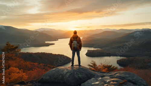 a man standing on a rock overlooking a body of water