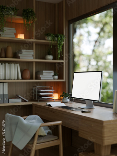 A modern, comfortable home office with a white-screen computer mockup on a wooden desk.