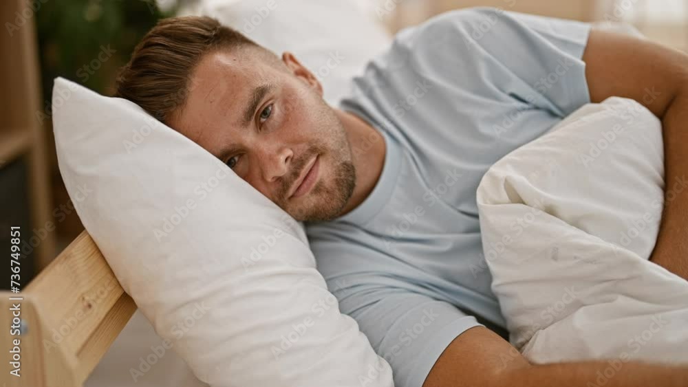 A relaxed, bearded young man lounging in bed with a serene expression in a cozy room setting A relaxed, bearded young man lounging in bed with a serene expression in a cozy room setting
