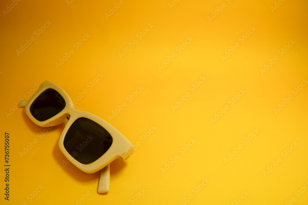 Hipster eyeglasses in pastel frames on a yellow background. Stylish eyeglasses. Retro fashion bold frame style. Space for text. Hipster eyeglasses in pastel frames on a yellow background. Stylish eyeglasses. Retro fashion bold frame style. Space for text.