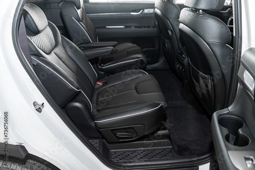 Black leather interior design, car passenger and driver seats with seats belt. © Виталий Сова