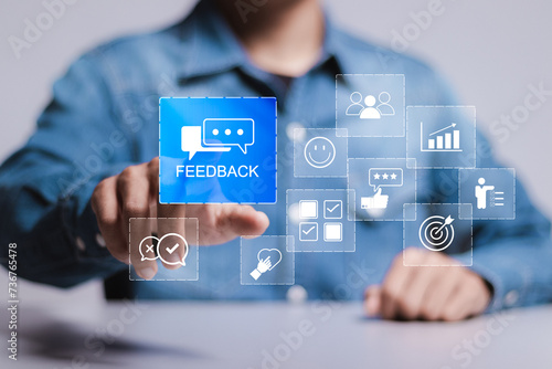 Feedback concept. Company online user feedback rating, reputation management and satisfaction survey. Person touching feedback icon on virtual screen.
