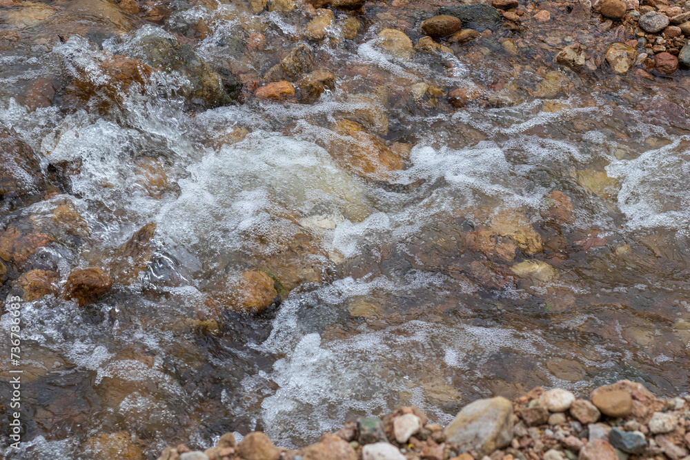 Mountain river spring season with sand and stone shoals along the banks.