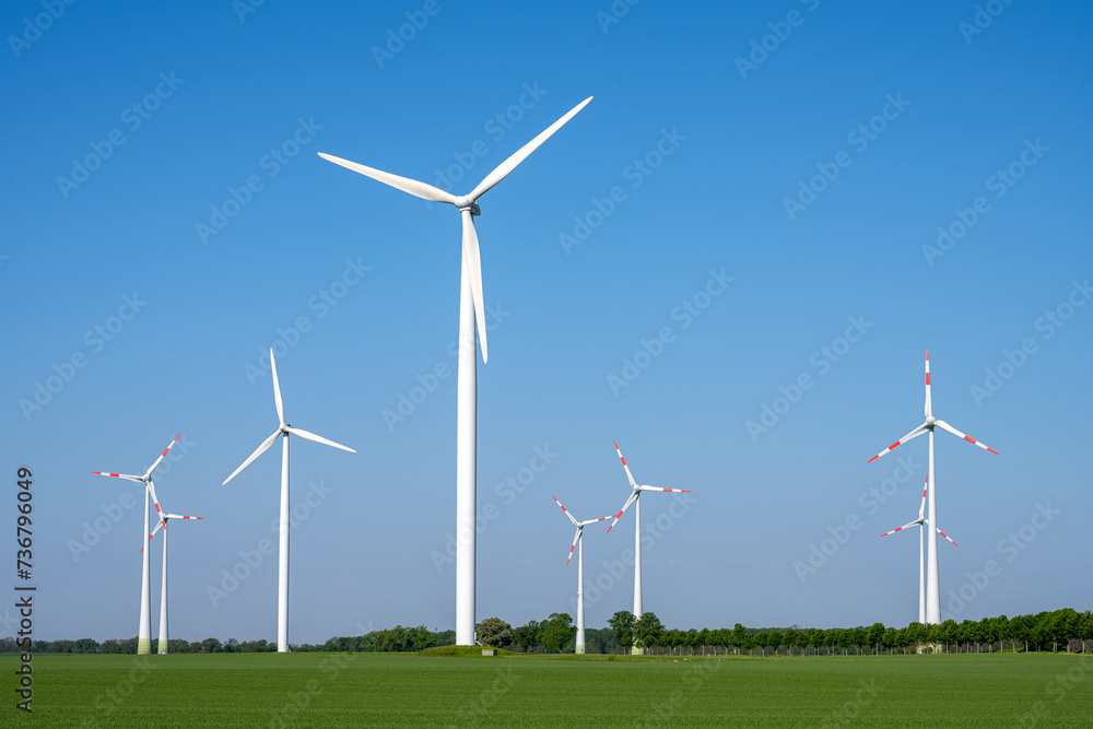 Modern wind turbines in front of a blue sky seen in rural Germany Modern wind turbines in front of a blue sky seen in rural Germany