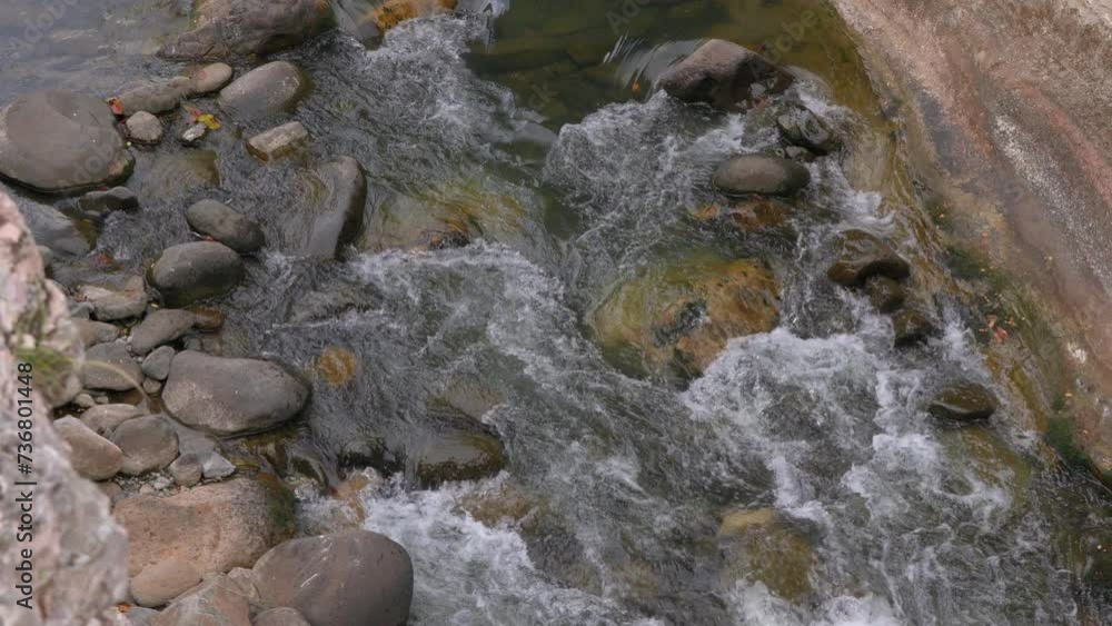 Rushing stream over rocks in Cajones de Chame, Panama, vibrant natural scene Rushing stream over rocks in Cajones de Chame, Panama, vibrant natural scene