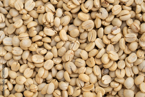 Unroasted green Arabica coffee beans flat surface. Backgrounds. Closeup macro food photo directly from above. photo