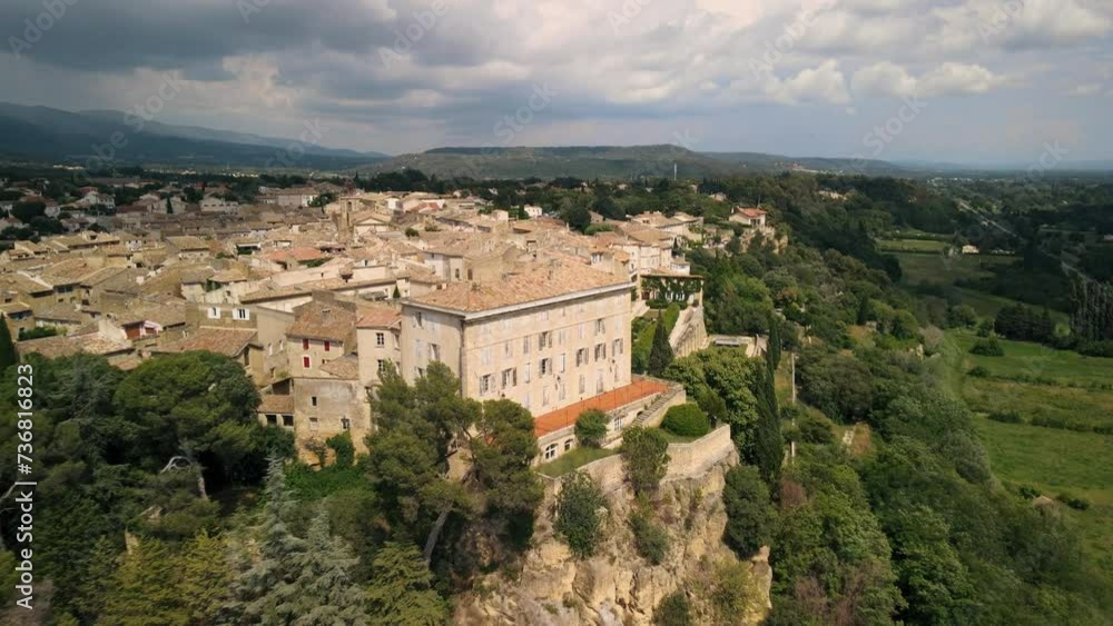 Aerial rising shot revealing the Lauris commune on a cliff in France Aerial rising shot revealing the Lauris commune on a cliff in France