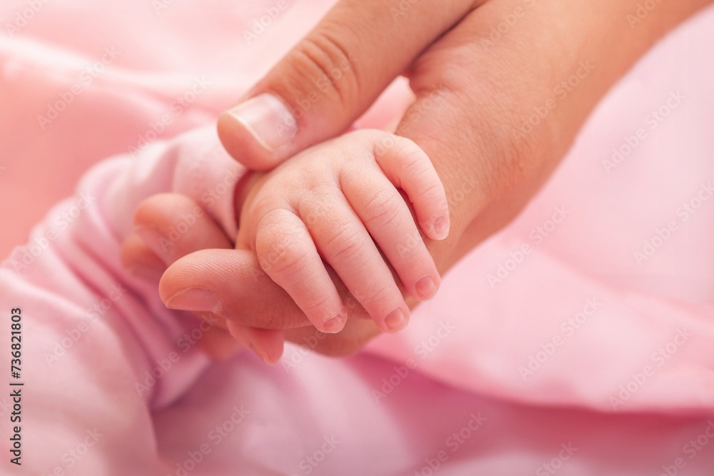 Mother holding newborn baby girl hand Mother holding newborn baby girl hand