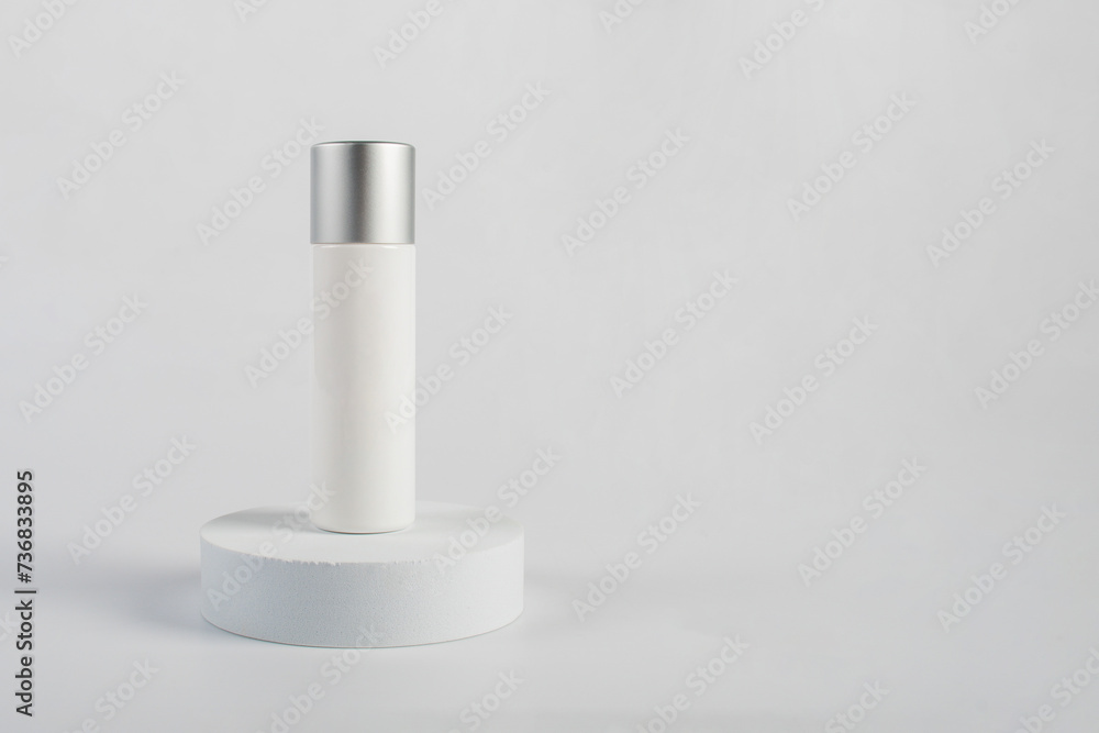 Plastic white tube for cream or lotion. Skin care or sunscreen cosmetic with stylish props on white background Plastic white tube for cream or lotion. Skin care or sunscreen cosmetic with stylish props on white background