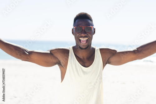 African American man enjoys the sun at the beach unaltered