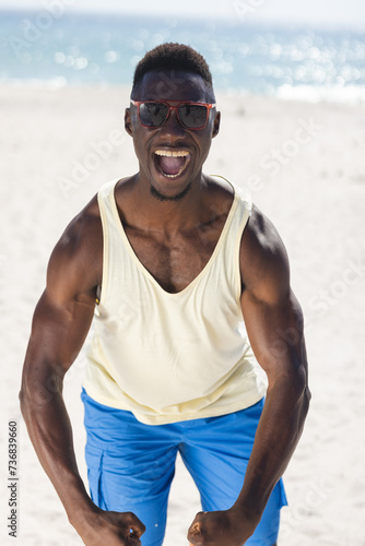 Young African American man enjoys a sunny beach day unaltered