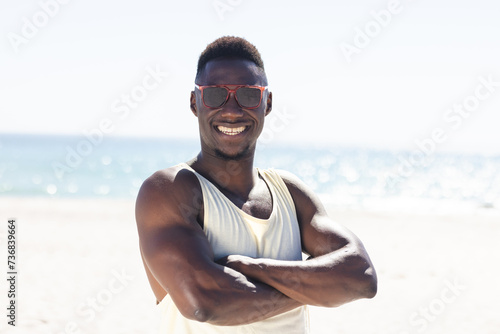 African American man smiles at the beach
