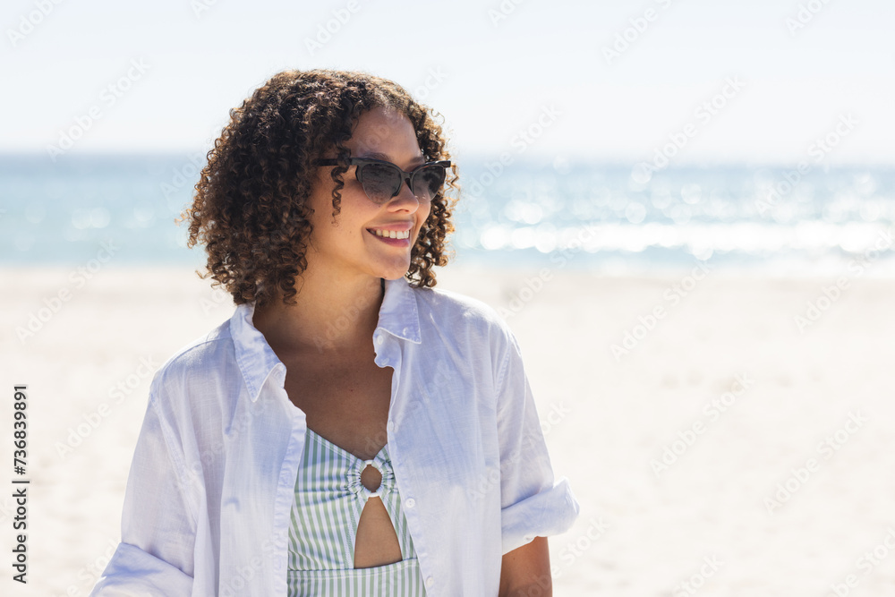Young biracial woman enjoys a sunny beach day Young biracial woman enjoys a sunny beach day