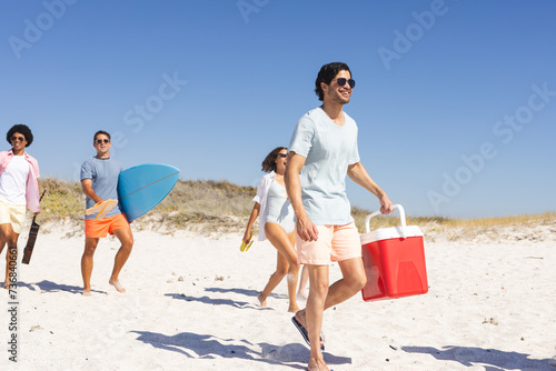 A diverse group of friends enjoys a sunny day at the beach