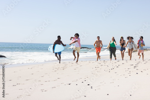 Diverse group of friends enjoy a day at the beach with copy space