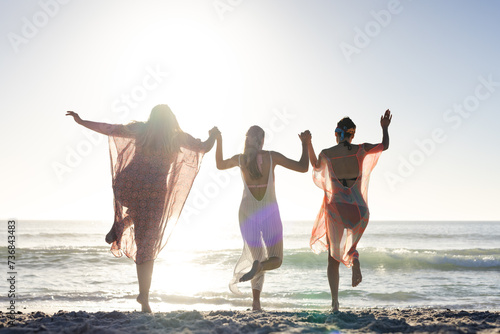 Three women enjoy a sunny beach day