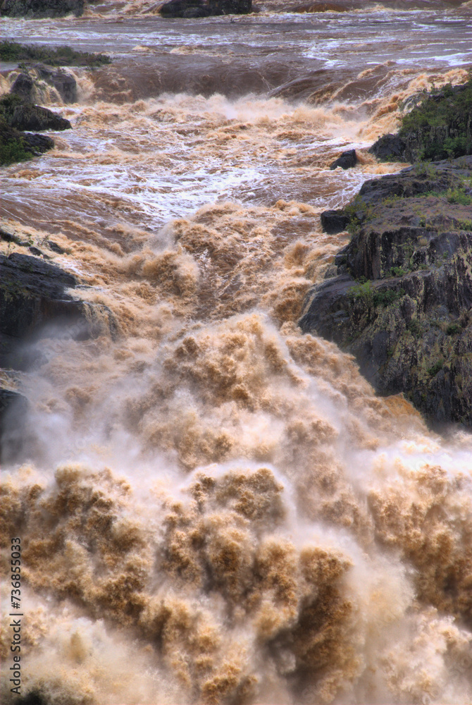 CAIRNS, AUSTRALIA - JAN 22 : Flooded Barron River entering the Barron River Gorge north of Cairns January 22, 2011 in Cairns, Queensland, Australia CAIRNS, AUSTRALIA - JAN 22 : Flooded Barron River entering the Barron River Gorge north of Cairns January 22, 2011 in Cairns, Queensland, Australia