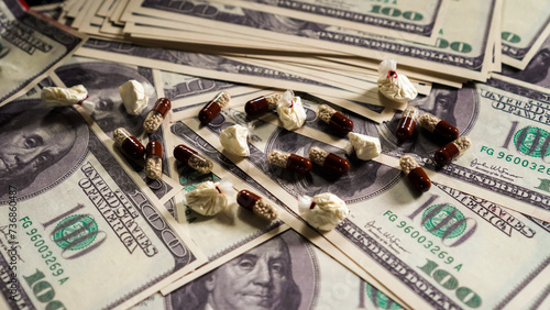 Criminal money from the sale of drugs. Bookmarks of cocaine and pills. Close-up. Stop drugs.	 photo