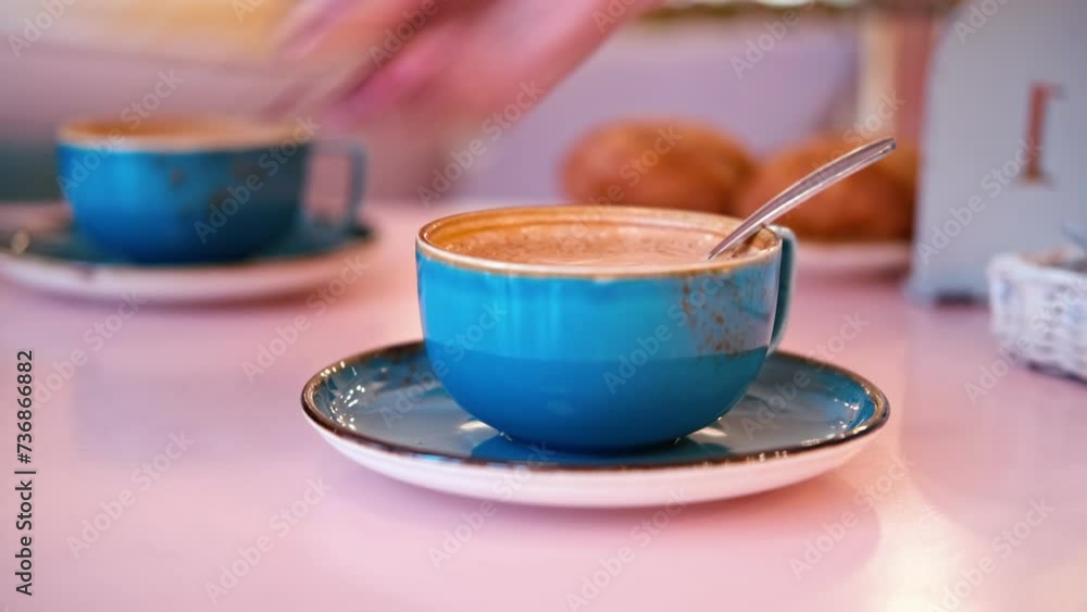 Сup of Cappuccino with Art Milk Foam Top View. Latte with Steel Spoon. Hot Coffee in a Blue Ceramic Mug With Saucer on a Pink Table. Modern Glamour Coffee Shop, Cafeteria. Thick Froth. No People. 4K
Сup of Cappuccino with Art Milk Foam Top View. Latte with Steel Spoon. Hot Coffee in a Blue Ceramic Mug With Saucer on a Pink Table. Modern Glamour Coffee Shop, Cafeteria. Thick Froth. No People. 4K