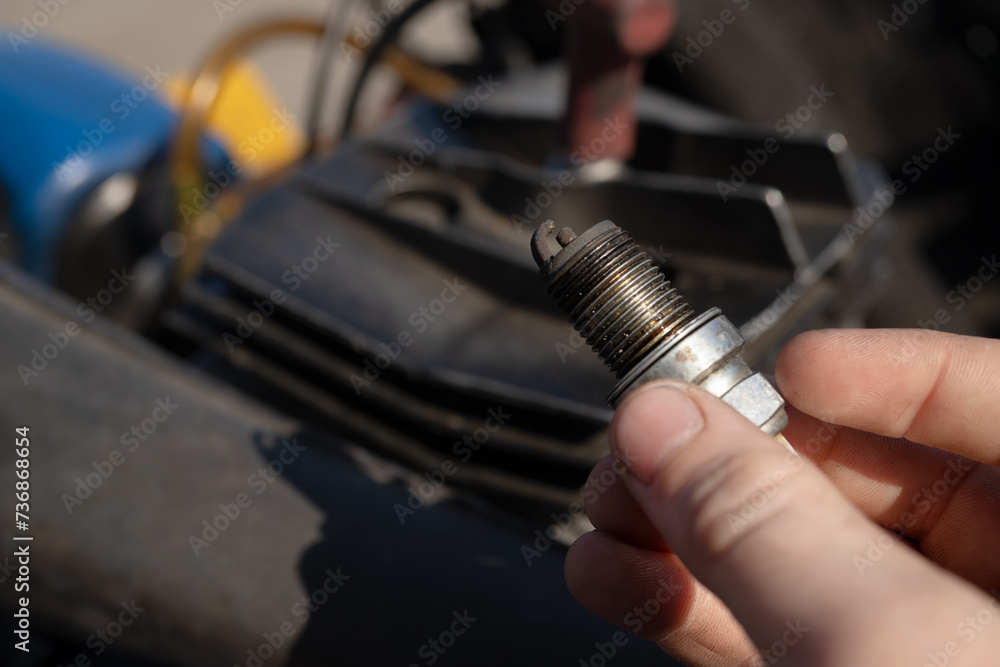Fotografie Deteriorated and blackened car spark plug