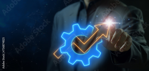 Foto Businessman pointing his finger to the front that showing neon cogwheel with up arrow