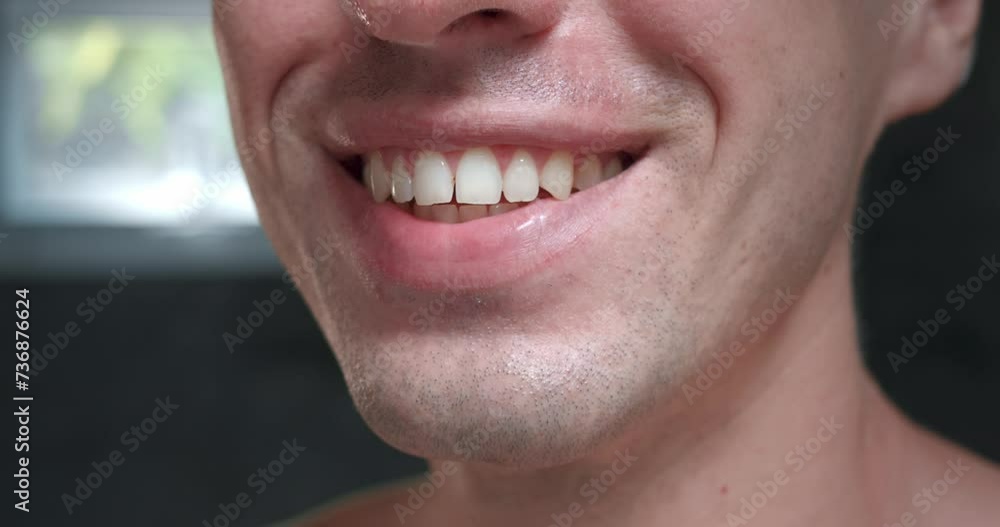 Close-up man smiling dazzling smile showing snow-white teeth. Teeth shine with health and cleanliness giving him attractiveness and confidence. Beauty and shine of his teeth which create unique image. Close-up man smiling dazzling smile showing snow-white teeth. Teeth shine with health and cleanliness giving him attractiveness and confidence. Beauty and shine of his teeth which create unique image.