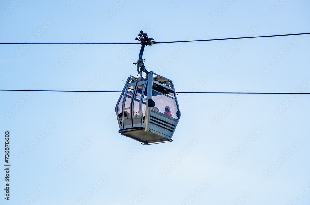 Cable car against the sky. ficicular cabins transport tourists to the mountains Cable car against the sky. ficicular cabins transport tourists to the mountains
