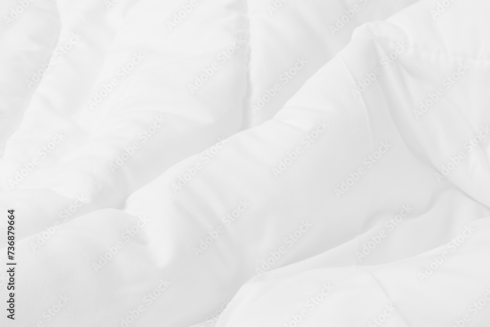 Close up top view of white bedding sheet and wrinkle messy blanket in bedroom after wake up in the morning.