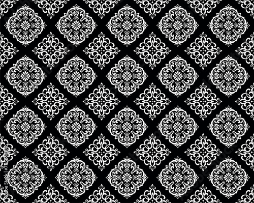 Wallpaper in the style of Baroque. Seamless vector background. White and black floral ornament. Graphic pattern for fabric, wallpaper, packaging. Ornate Damask flower ornament