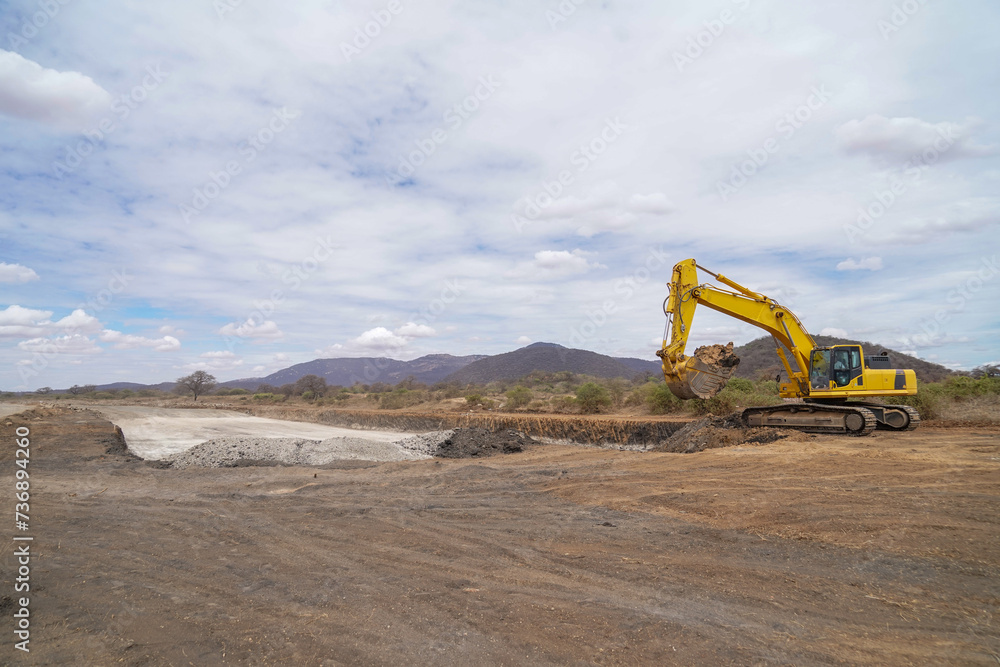 construction machines at works, dozer, roller machine, excavator, crawler rock drill machine, trucks, GPS grader