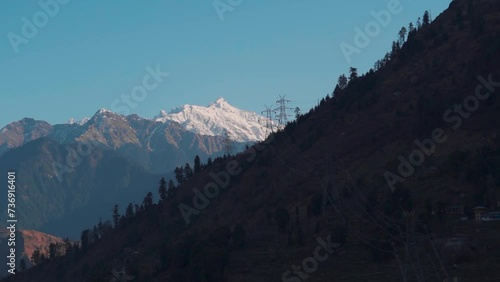 Snowy mountain peaks of the Himalayan mountain range during winter season as seen from Sarahan village in Shimla District, Himachal Pradesh, India. Snow covered Himalayas during winter season.	 photo