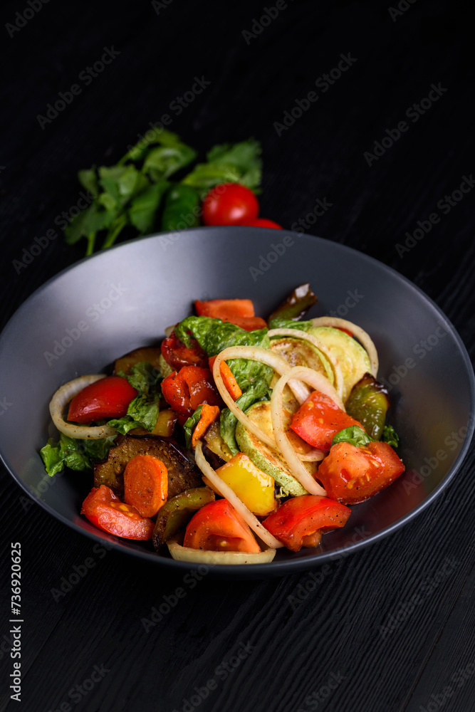 Korean food. Tofu, chicken meat with vegetables. on a black wooden background Korean food. Tofu, chicken meat with vegetables. on a black wooden background