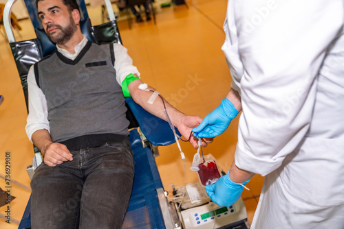 Doctor collecting blood from a donor into a bag © unai