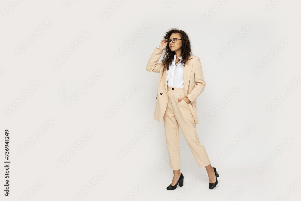Attractive businesswoman in a suit on a light background Attractive businesswoman in a suit on a light background