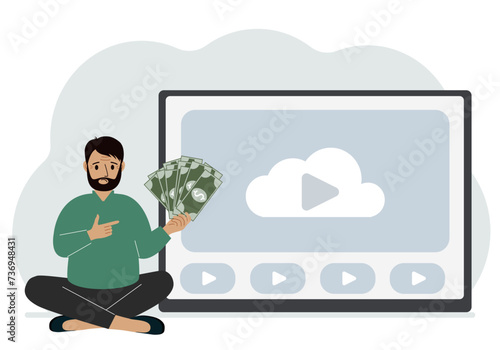 A man holds paper banknotes in his hand, next to a computer with a video. Freelancer, earning money, working on the Internet, training, coaching, business, remote work.