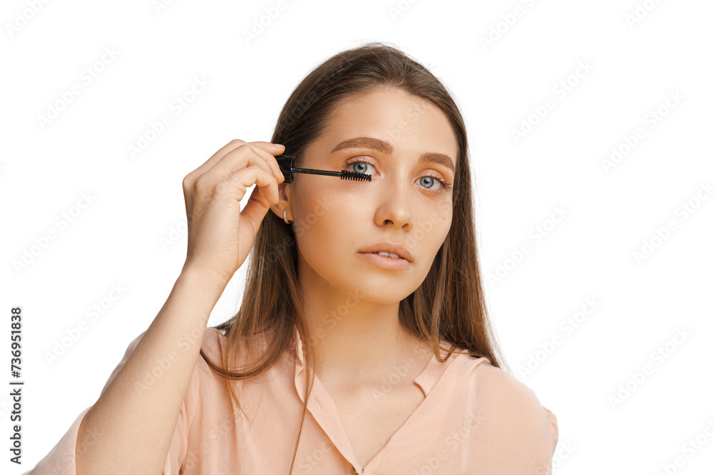 Studio shot of a young beautiful woman holding mascara brush near her blue eyes. Studio shot of a young beautiful woman holding mascara brush near her blue eyes.
