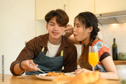 Loving young couple having romantic dinner together at home. People, relationships and food concept