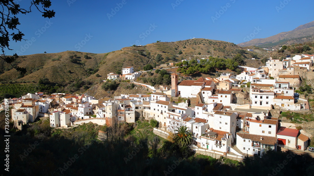 General view towards the village of Salares, Axarquia, Malaga province, Andalusia, Spain, with whitewashed houses and surrounded by mountains and trees