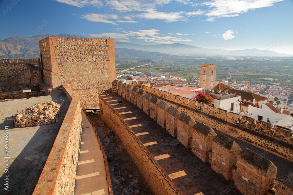 The ramparts of the Moorish Castle of Salobrena, Granada province, Andalusia, Spain, overlooking the town and with mountains in the background