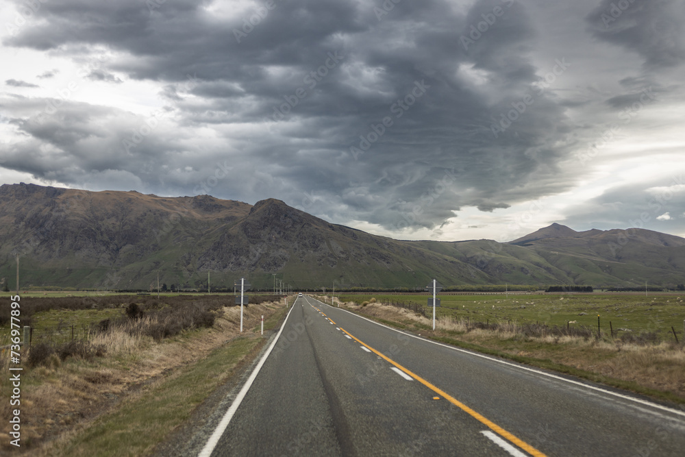 road with yellow line and storm clouds in New Zealand