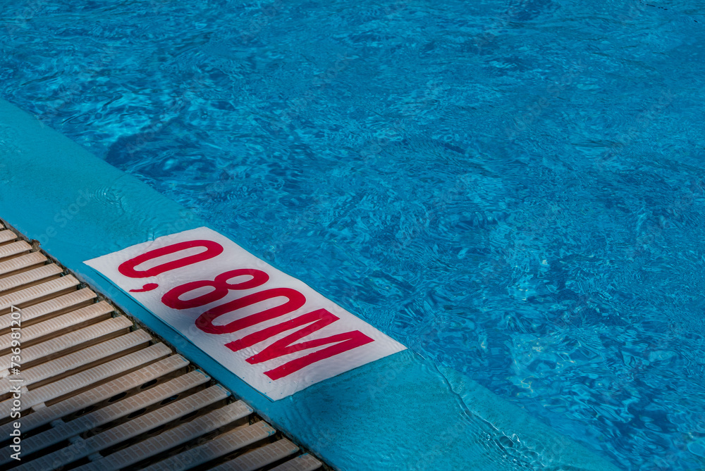 Depth marking at the edge of the pool. A small depth of 0.8 m in the children's pool.