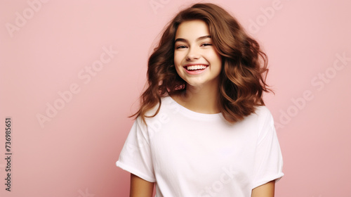 Smiling girl in white t-shirt on pink background mockup. Beautiful happy woman model looking at camera © EltaMax99