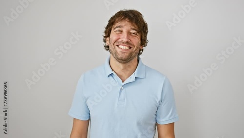 Hilarious young caucasian man puffing cheeks, making a crazy-fun face, inflated mouth full of air, catching breath over an isolated white background. photo