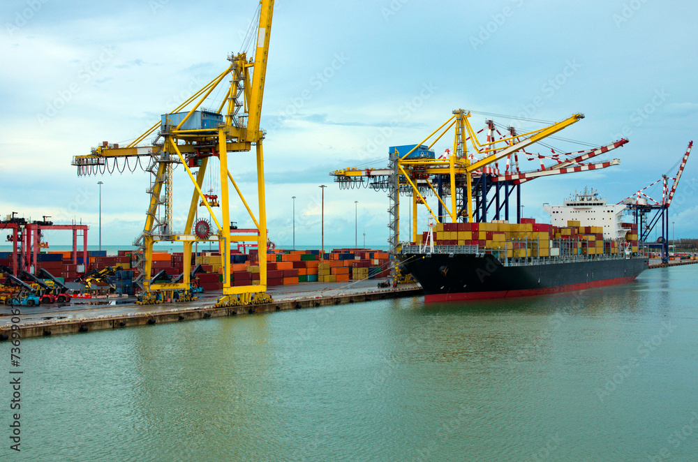 Container terminal with stowed containers from different shippers gantry cranes and straddle carriers in Livorno. Import, export and business logistic