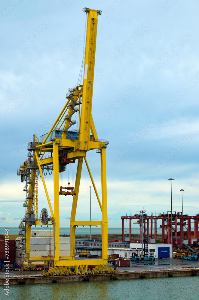 Detailed view of crane bridge for unloading or loading containers to the cargo freight ship from port area. Import, export and business logistic. International water transport Detailed view of crane bridge for unloading or loading containers to the cargo freight ship from port area. Import, export and business logistic. International water transport