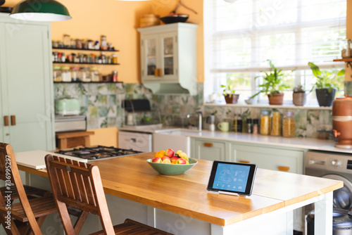 A modern kitchen interior features a smart home tablet photo